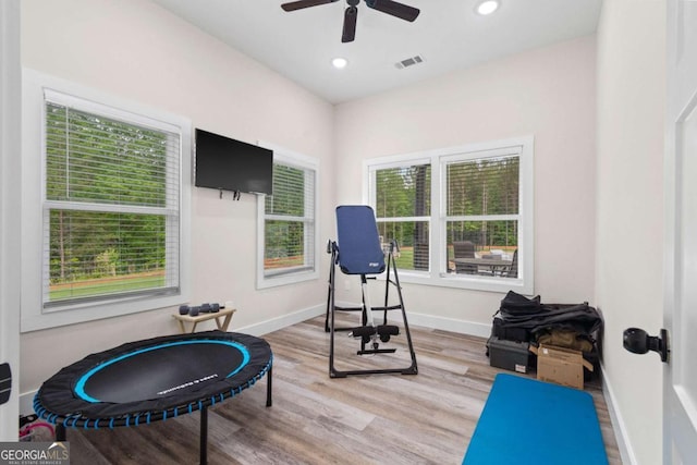 workout area with light wood-style floors, a ceiling fan, recessed lighting, and baseboards