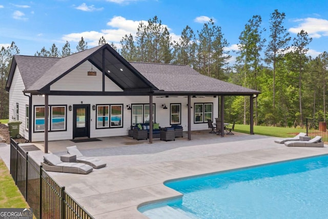 rear view of property with an outdoor hangout area, a patio, fence, and a shingled roof