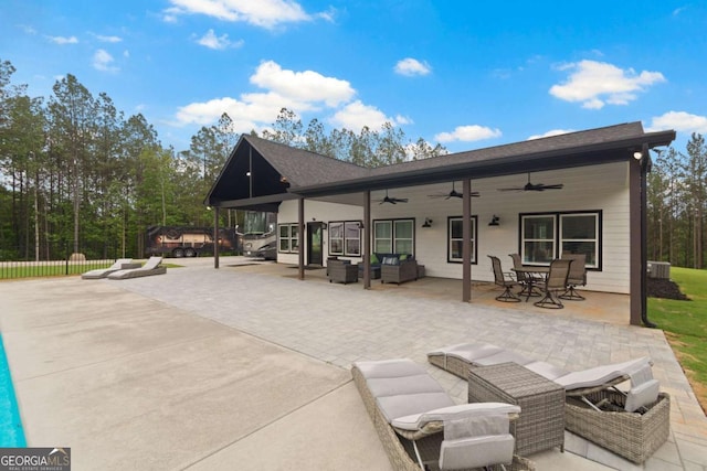 back of house featuring ceiling fan, an outdoor hangout area, a patio, fence, and outdoor dining space