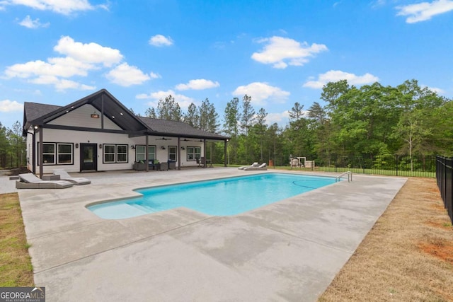 view of pool with a patio, a ceiling fan, and fence