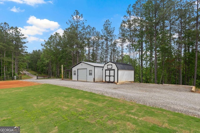 view of shed featuring gravel driveway and a forest view