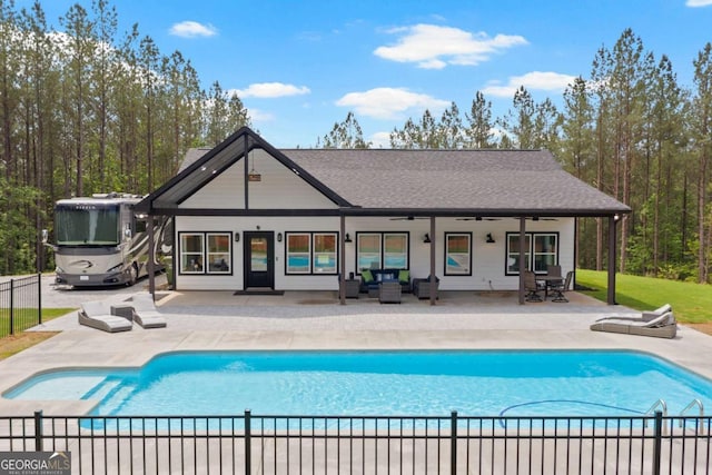 view of pool featuring outdoor lounge area, a ceiling fan, and a patio area