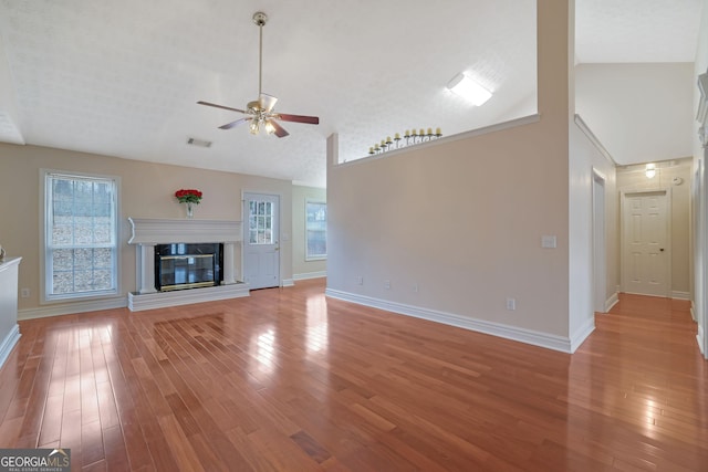 954 Josie Ct, Lawrenceville, GA 30045 - unfurnished living room featuring a ceiling fan, light wood-type flooring, healthy amount of natural light, and high vaulted ceiling