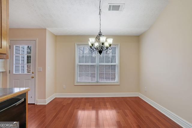 954 Josie Ct, Lawrenceville, GA 30045 - unfurnished dining area with a chandelier, wood-type flooring, and a textured ceiling