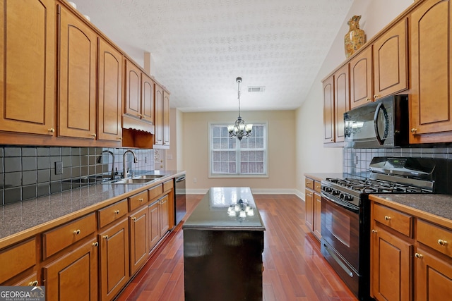 954 Josie Ct, Lawrenceville, GA 30045 - kitchen with black appliances, a chandelier, a textured ceiling, and brown cabinets