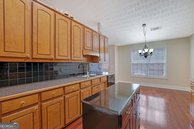 954 Josie Ct, Lawrenceville, GA 30045 - kitchen featuring dishwasher, tasteful backsplash, a chandelier, a textured ceiling, and dark wood-style flooring