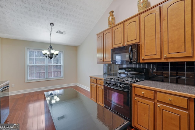954 Josie Ct, Lawrenceville, GA 30045 - kitchen featuring black appliances, a textured ceiling, dark wood-style flooring, dark countertops, and tasteful backsplash