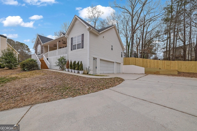 954 Josie Ct, Lawrenceville, GA 30045 - view of home's exterior with stairway, a garage, a ceiling fan, concrete driveway, and covered porch
