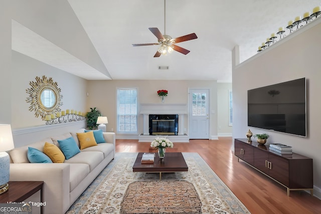 954 Josie Ct, Lawrenceville, GA 30045 - living area with wood finished floors, vaulted ceiling, a ceiling fan, and a fireplace