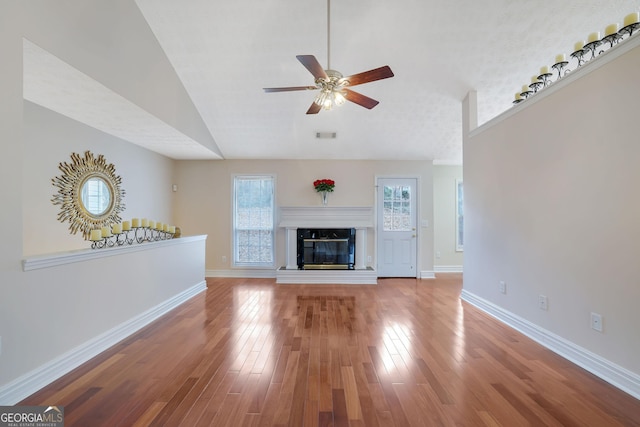 954 Josie Ct, Lawrenceville, GA 30045 - unfurnished living room featuring lofted ceiling, ceiling fan, wood finished floors, and a high end fireplace