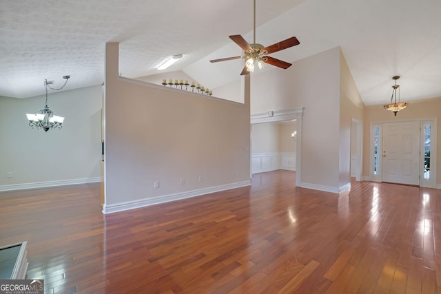 954 Josie Ct, Lawrenceville, GA 30045 - unfurnished living room featuring a chandelier, ceiling fan, wood finished floors, and high vaulted ceiling