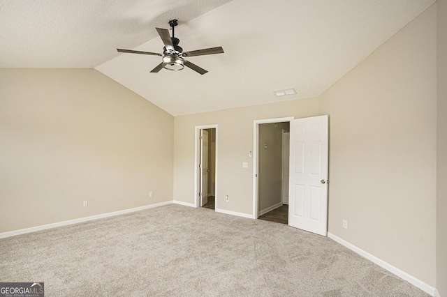 50 Fieldview Ln, Covington, GA 30016 - unfurnished bedroom featuring dark colored carpet, vaulted ceiling, and ceiling fan