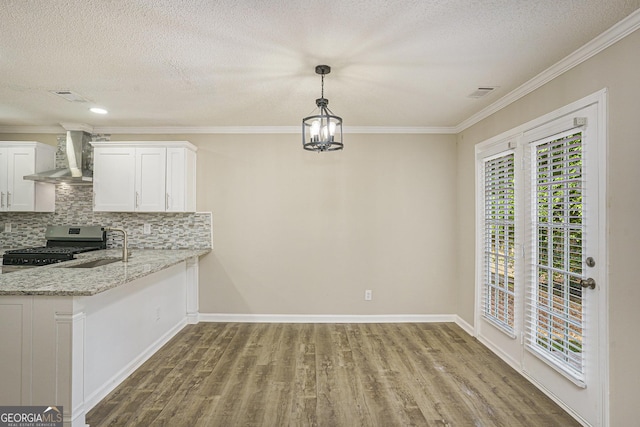 50 Fieldview Ln, Covington, GA 30016 - unfurnished dining area with wood finished floors, ornamental molding, and a textured ceiling