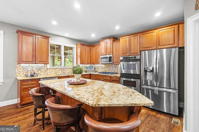 4840 Spring Park Cir, Suwanee, GA 30024 - kitchen featuring appliances with stainless steel finishes, a sink, tasteful backsplash, light stone counters, and recessed lighting