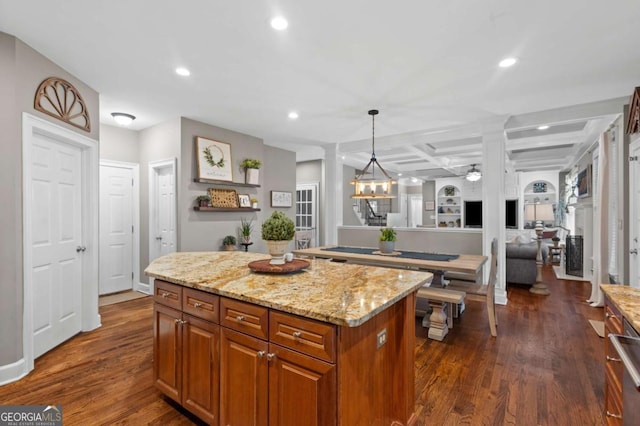 4840 Spring Park Cir, Suwanee, GA 30024 - kitchen with coffered ceiling, recessed lighting, brown cabinets, dark wood-style flooring, and a center island