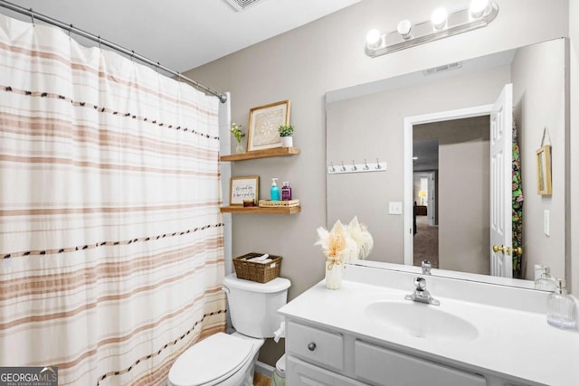 4840 Spring Park Cir, Suwanee, GA 30024 - bathroom with toilet, vanity, and curtained shower