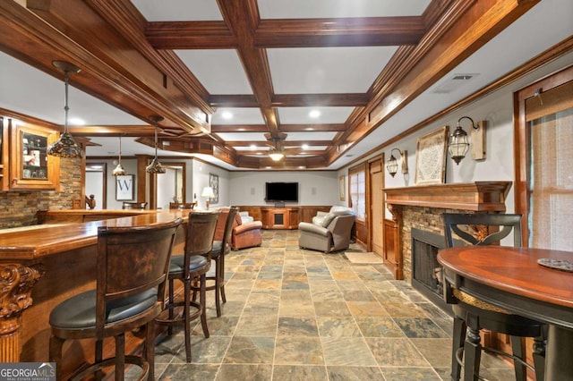 4840 Spring Park Cir, Suwanee, GA 30024 - dining space with a stone fireplace, coffered ceiling, beam ceiling, ceiling fan, and stone finish flooring