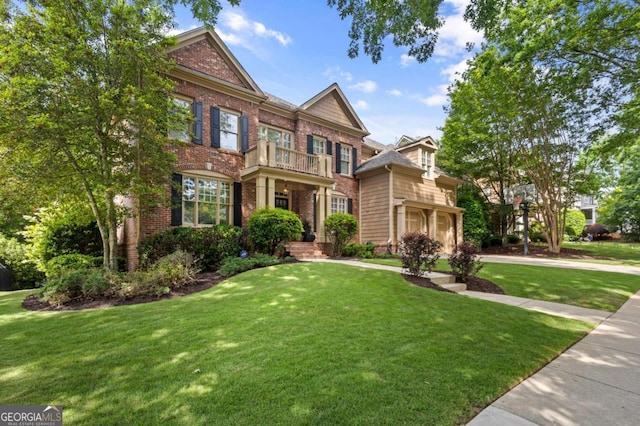 4840 Spring Park Cir, Suwanee, GA 30024 - colonial home with a balcony, brick siding, and a front yard