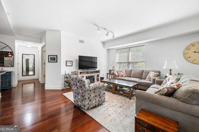 200 River Vista Dr Unit 120, Atlanta, GA 30339 - living area featuring dark wood-style floors, rail lighting, and baseboards