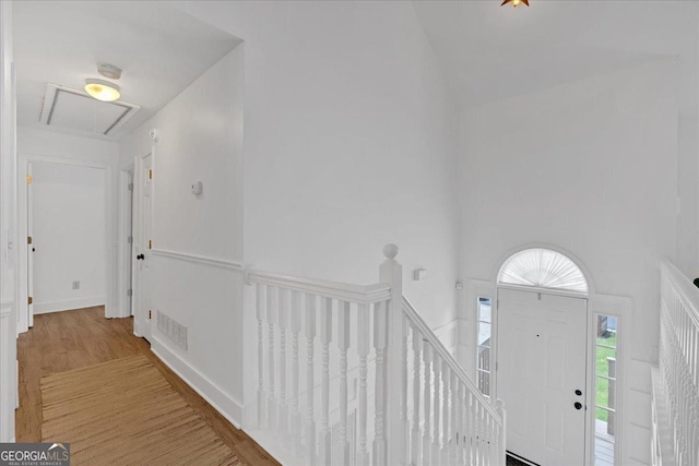 foyer entrance featuring light wood-style flooring and high vaulted ceiling