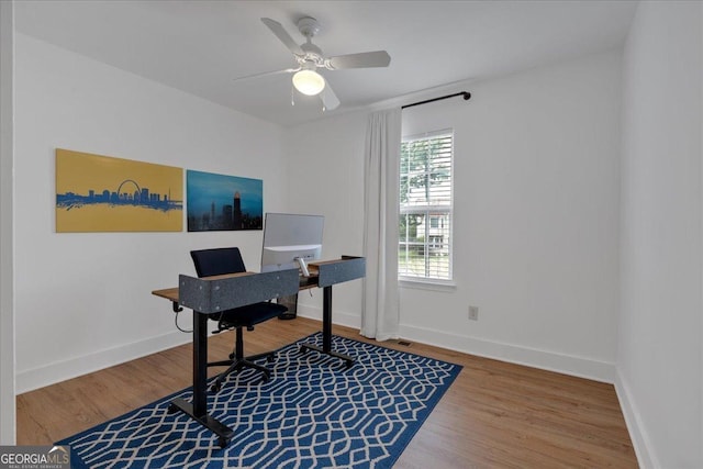 office area featuring wood finished floors, baseboards, and a ceiling fan