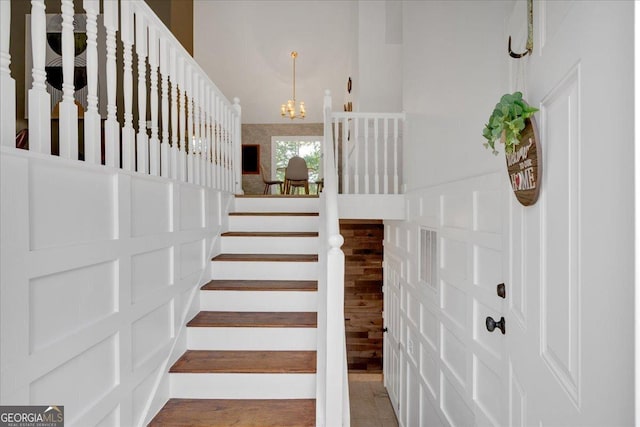 stairs with a chandelier