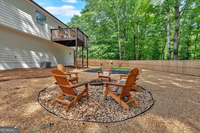 view of patio featuring an outdoor fire pit, a fenced backyard, a balcony, and cooling unit