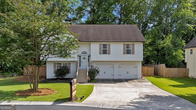 raised ranch featuring driveway and an attached garage