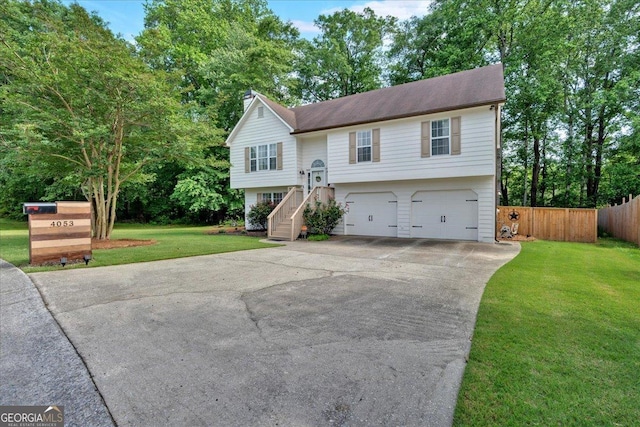 split foyer home with an attached garage, driveway, and stairway