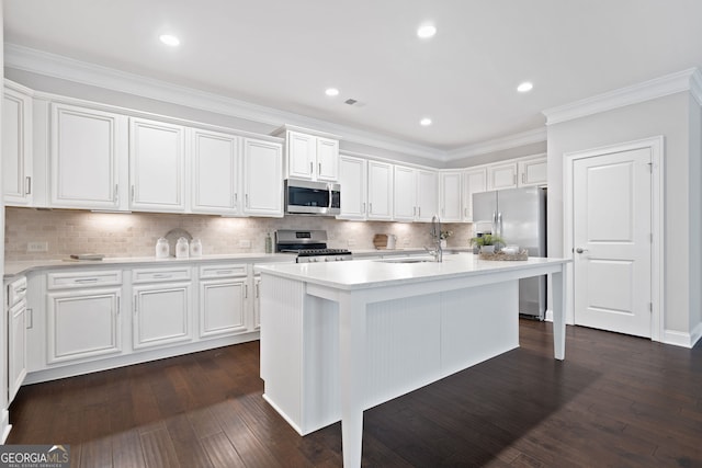 2499 Barrett Preserve Ct SW, Marietta, GA 30064 - kitchen with a sink, appliances with stainless steel finishes, light countertops, white cabinets, and crown molding