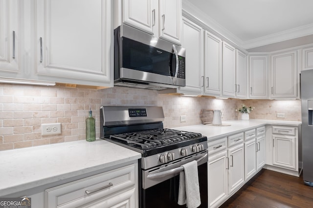 2499 Barrett Preserve Ct SW, Marietta, GA 30064 - kitchen with stainless steel appliances, ornamental molding, white cabinetry, decorative backsplash, and light stone counters