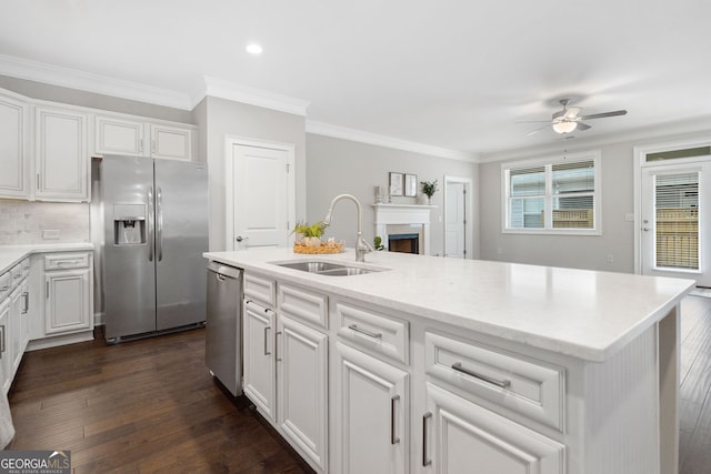 2499 Barrett Preserve Ct SW, Marietta, GA 30064 - kitchen featuring appliances with stainless steel finishes, a sink, ceiling fan, dark wood-style floors, and crown molding