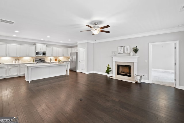 2499 Barrett Preserve Ct SW, Marietta, GA 30064 - living room featuring a ceiling fan, a fireplace with flush hearth, dark wood-type flooring, recessed lighting, and crown molding
