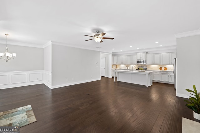 2499 Barrett Preserve Ct SW, Marietta, GA 30064 - unfurnished living room featuring a sink, a chandelier, a ceiling fan, dark wood-style flooring, and ornamental molding