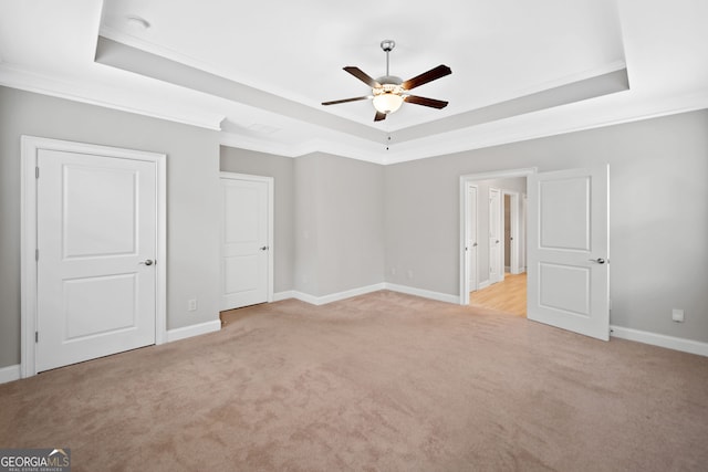 2499 Barrett Preserve Ct SW, Marietta, GA 30064 - unfurnished bedroom with a tray ceiling, light carpet, ornamental molding, baseboards, and a ceiling fan