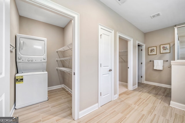 2499 Barrett Preserve Ct SW, Marietta, GA 30064 - laundry area featuring stacked washer / dryer, baseboards, and wood tiled floors