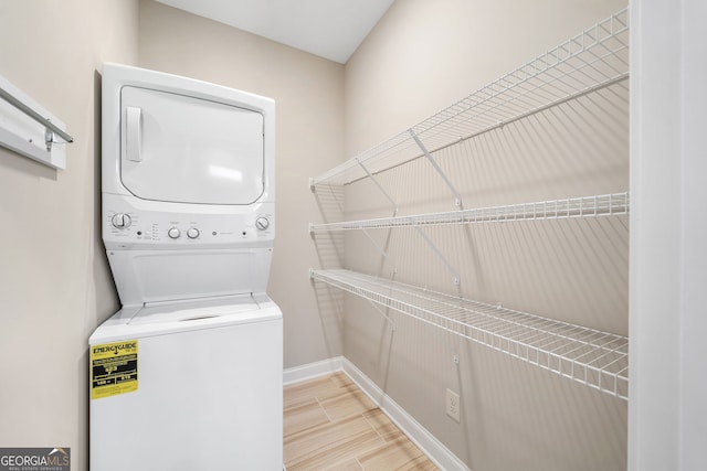2499 Barrett Preserve Ct SW, Marietta, GA 30064 - washroom featuring estacked washer and dryer and baseboards