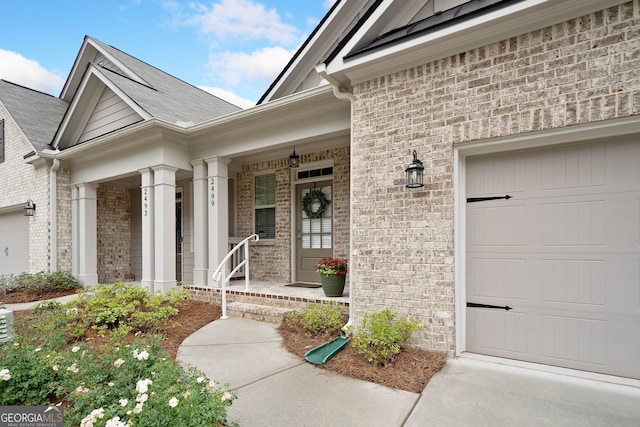 2499 Barrett Preserve Ct SW, Marietta, GA 30064 - view of exterior entry with a garage, brick siding, and covered porch