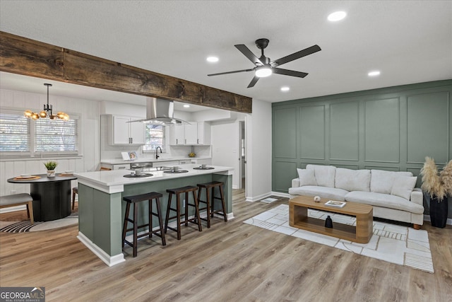 2378 Green Forrest Dr, Decatur, GA 30032 - living room with a decorative wall, ceiling fan, light wood-style floors, recessed lighting, and a chandelier