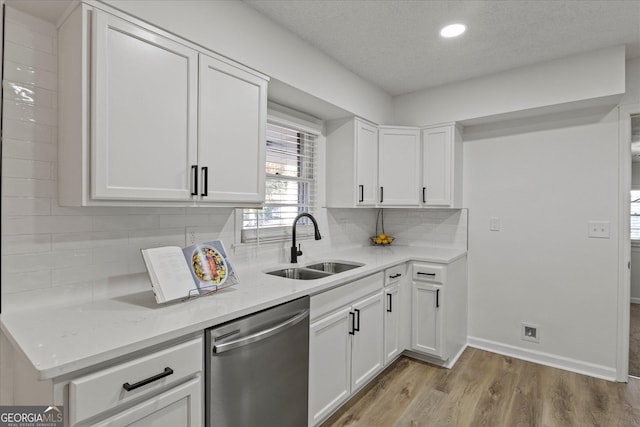 2378 Green Forrest Dr, Decatur, GA 30032 - kitchen with dishwasher, a sink, white cabinets, light wood finished floors, and decorative backsplash