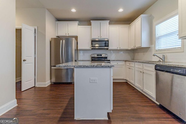 395 Dublin Way, Dallas, GA 30132 - kitchen with stainless steel appliances, white cabinetry, dark wood-style floors, a center island, and recessed lighting