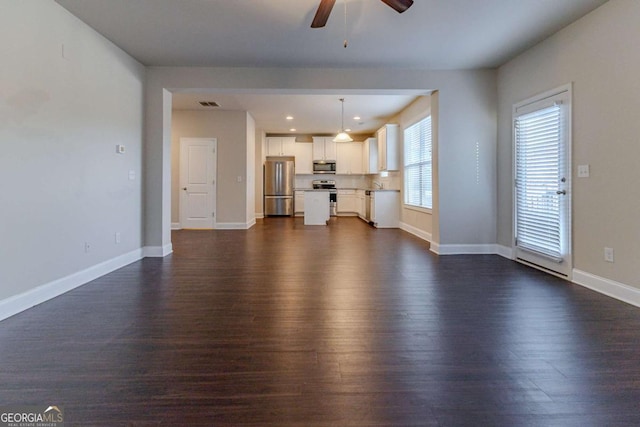 395 Dublin Way, Dallas, GA 30132 - unfurnished living room with dark wood-style floors, ceiling fan, baseboards, and recessed lighting