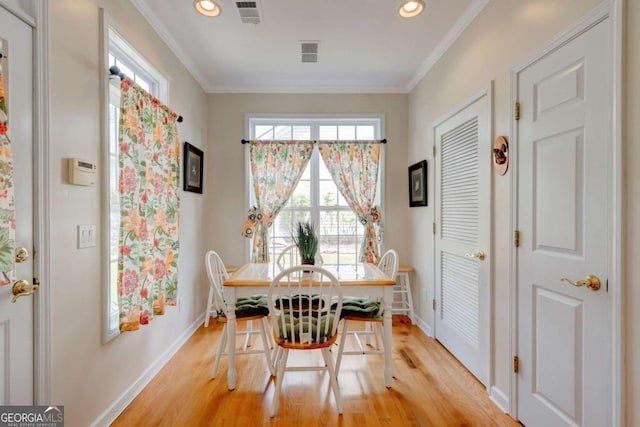 2707 Mariner Way, Villa Rica, GA 30180 - dining room featuring light wood-style flooring, baseboards, plenty of natural light, recessed lighting, and crown molding