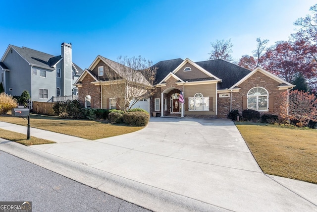 2041 Democracy Dr, Buford, GA 30519 - traditional-style home featuring driveway, a front yard, and brick siding