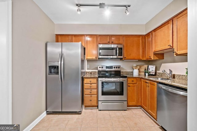 3200 Seven Pines Ct Unit 103, Atlanta, GA 30339 - kitchen with stainless steel appliances, a sink, dark stone countertops, and brown cabinets