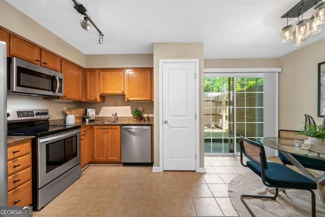 3200 Seven Pines Ct Unit 103, Atlanta, GA 30339 - kitchen with appliances with stainless steel finishes, a sink, light tile patterned flooring, and brown cabinets