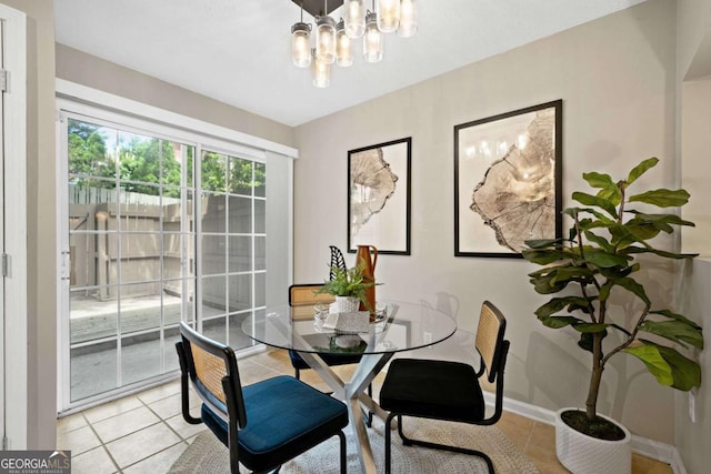 3200 Seven Pines Ct Unit 103, Atlanta, GA 30339 - dining space featuring light tile patterned floors, a chandelier, and baseboards