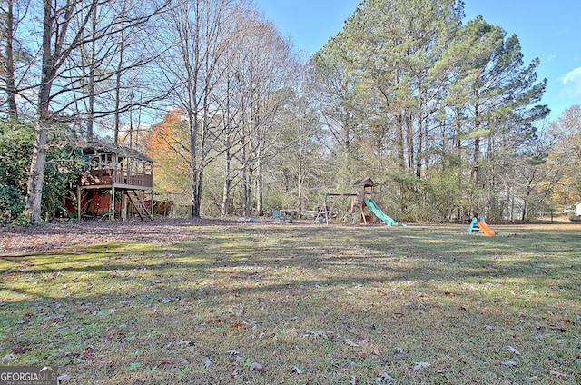 view of green lawn with a playground