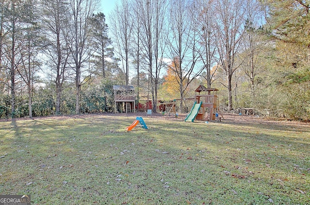 view of green lawn featuring a playground