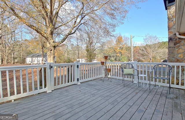 wooden terrace with a shed and an outbuilding
